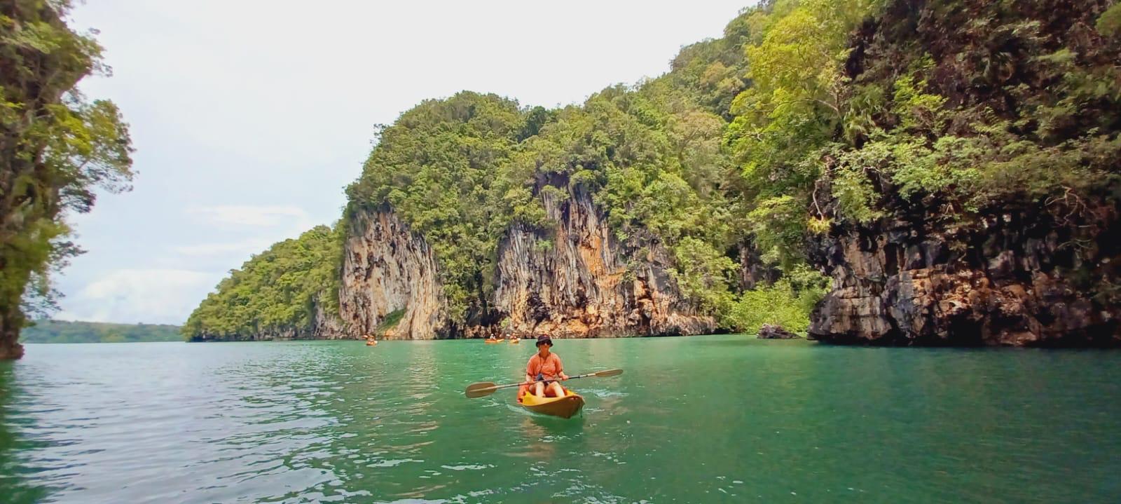 Bri kayaking between cliffs